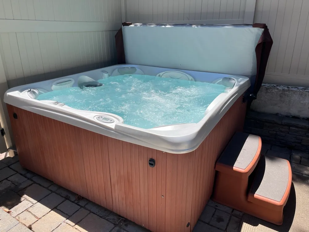 Hot tub with jets running and clear water after a routine maintenance visit in the Salt Lake Valley