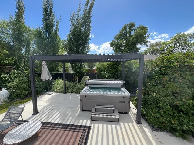 Hot tub on routine maintenance under a pergola in a Salt Lake Valley backyard